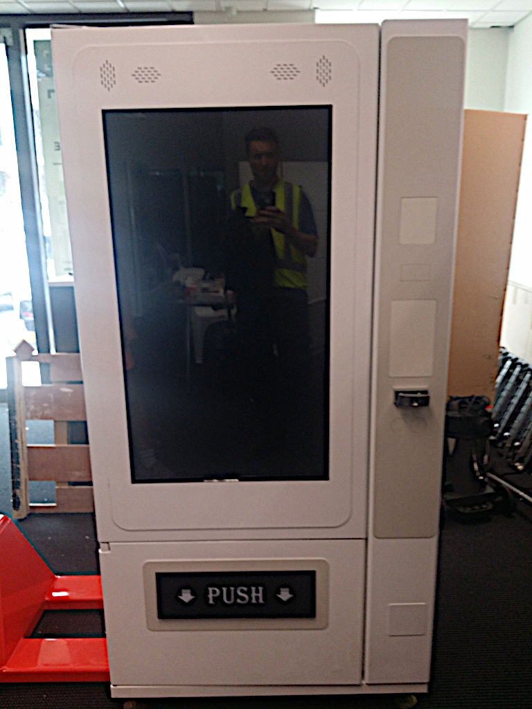 <p>The machine prototype was repurposed from a generic snack-vending machine. We fitted a 42inch LCD screen inside the glass, and installed an Intel NUC PC into where the cash-collection mechanism was housed. </p><p> After testing several permutations, we settled on a design that optimised the placement of the web-camera and completed the fitting of spiral dispensers at the correct size for the standard Cadbury 250gm block of chocolate.
