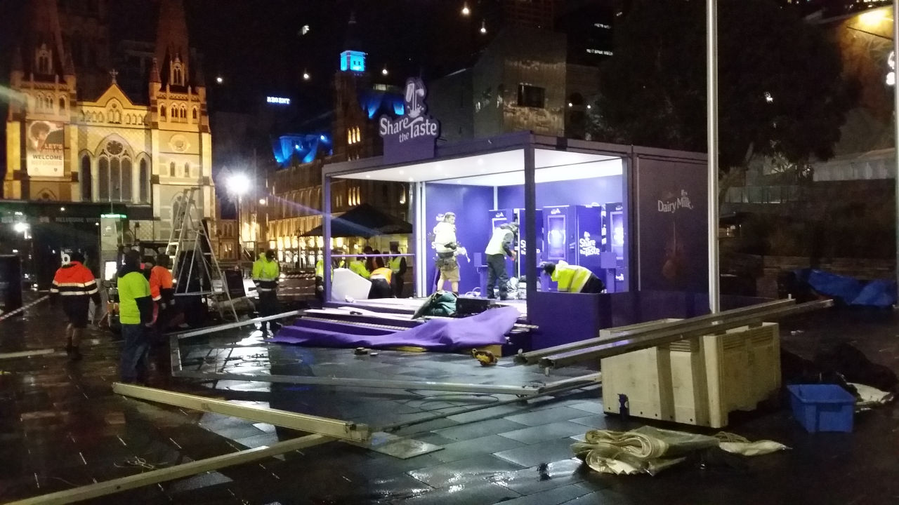 <p>We worked with Bestoh Productions to install each of the sites during the night before launch. Our crew had access to Melbourne's Federation Square at 9pm the night before launch and by 10pm it was pouring with rain. </p><p>At about 3am, we decided to install a large marquee over the top of the site to provide shelter for the machines and the expected crowds.  This  proved to be an excellent decision as the marquee became a buzzy enclave for commuters seeking shelter from the rain throughout the day.</p> <p> In contrast, our sites in Perth, Sydney and Brisbane were clear and warm during installation and sunny throughout the day.</p>
			<img src="img/cadbury/rc_cadbury12.jpg " class="w3-image portImg"><br>
			
			